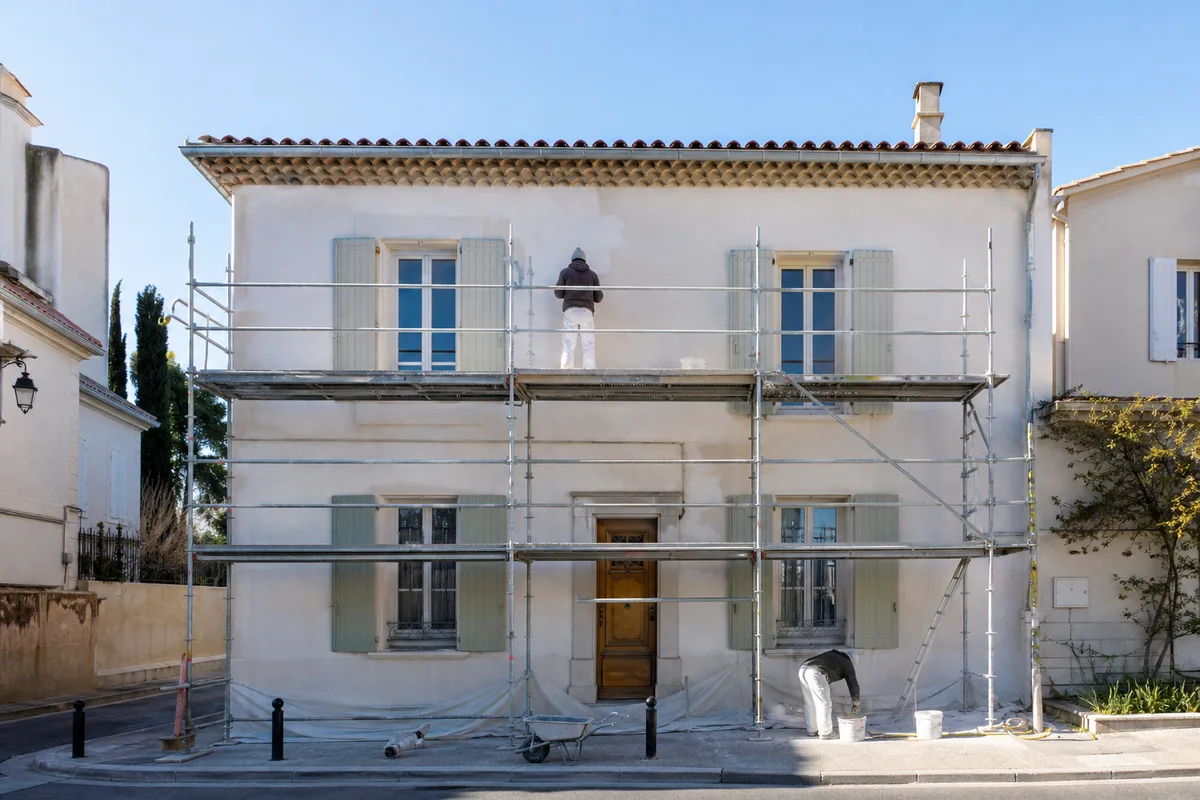 Entreprise de ravalement au travail sur une façade montpelliéraine avec échafaudage